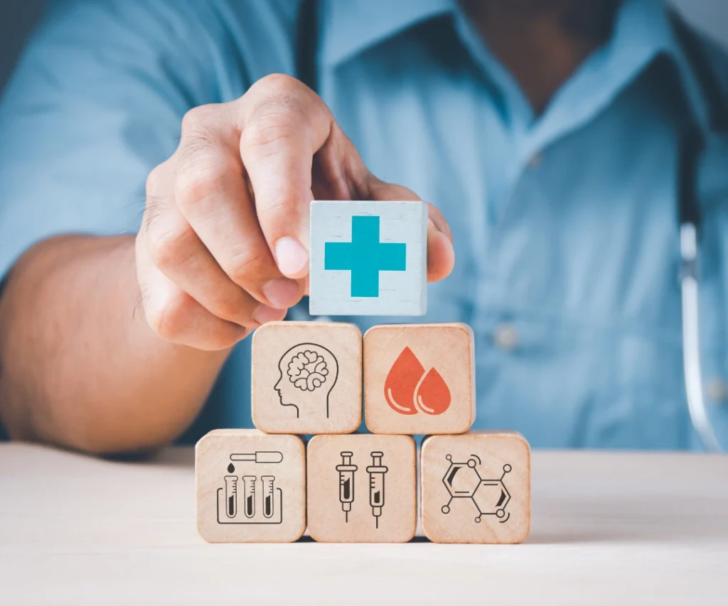 Blocks symbolizing healthcare services arranged by a doctor, representing the comprehensive coverage offered by private medical insurance